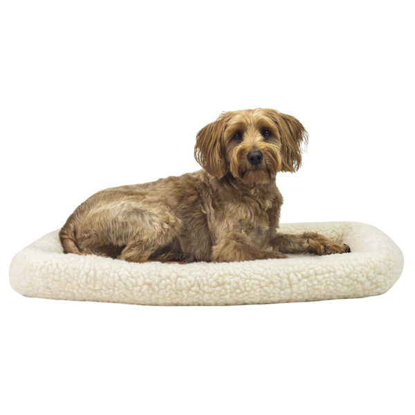 A tan terrier mix resting on a cream sherpa bolster pet bed