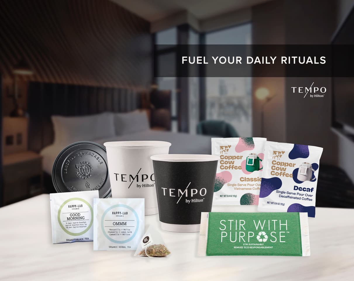 Tempo by Hilton in-room beverage setup with Copper Cow Coffee pour-over packets and Happy Lab organic tea sachets